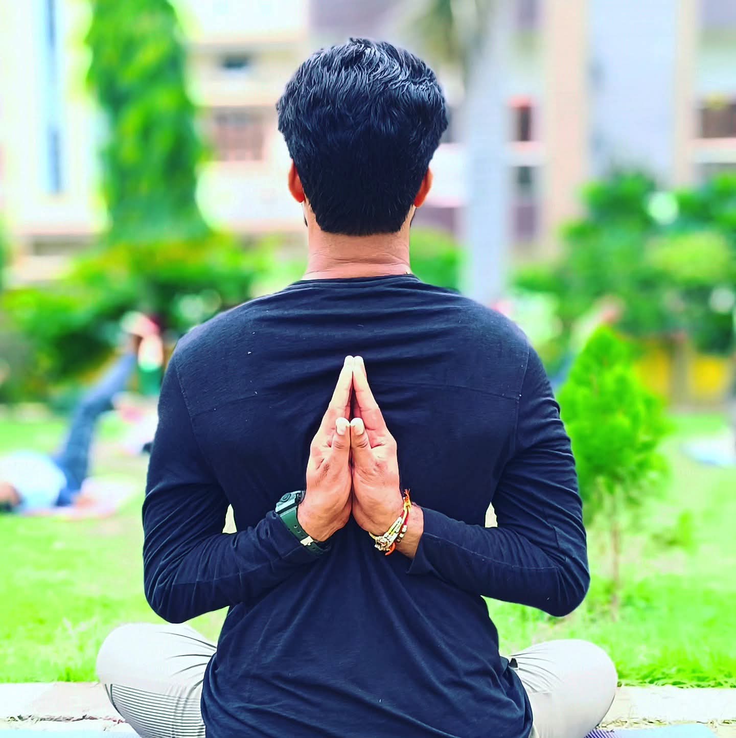 Aditya Pratap Singh, Founder of Yogic Hours, seated in reverse prayer