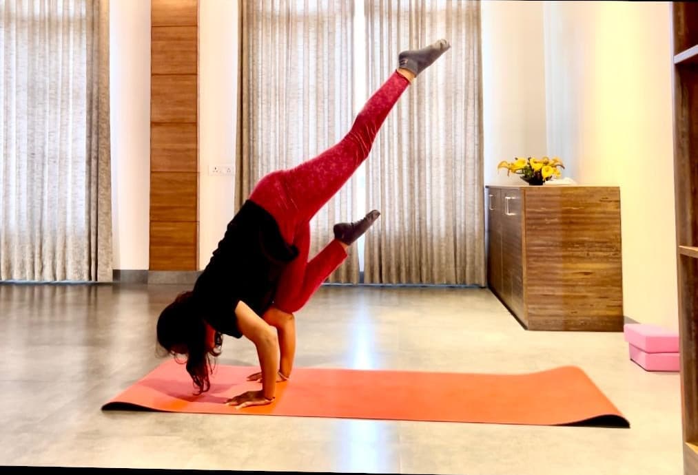 Shiya Shahi in a forearm balance with one leg raised